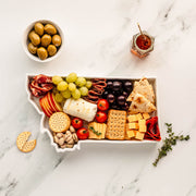 charcuterie board with cheese and cured meats in a Montana shaped serving tray platter dish