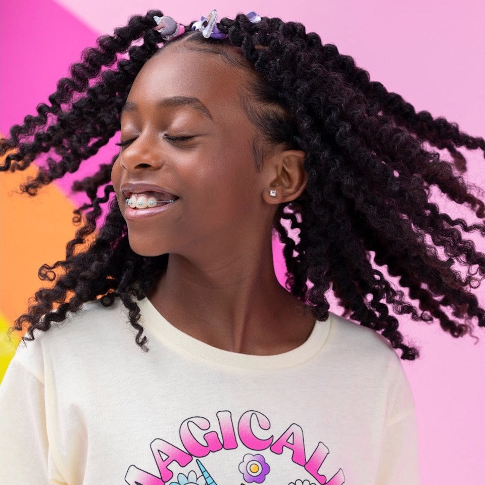 A model smiling while shaking her head.